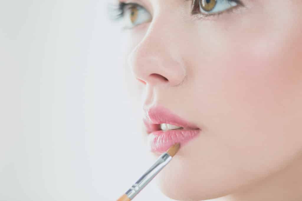 Add concealer and powder to create a fuller lip look