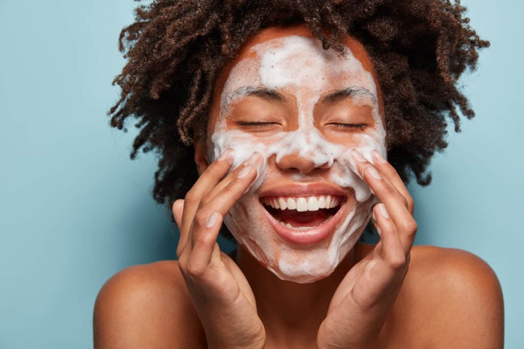 photo-of-a-woman-applying-face-skin-care